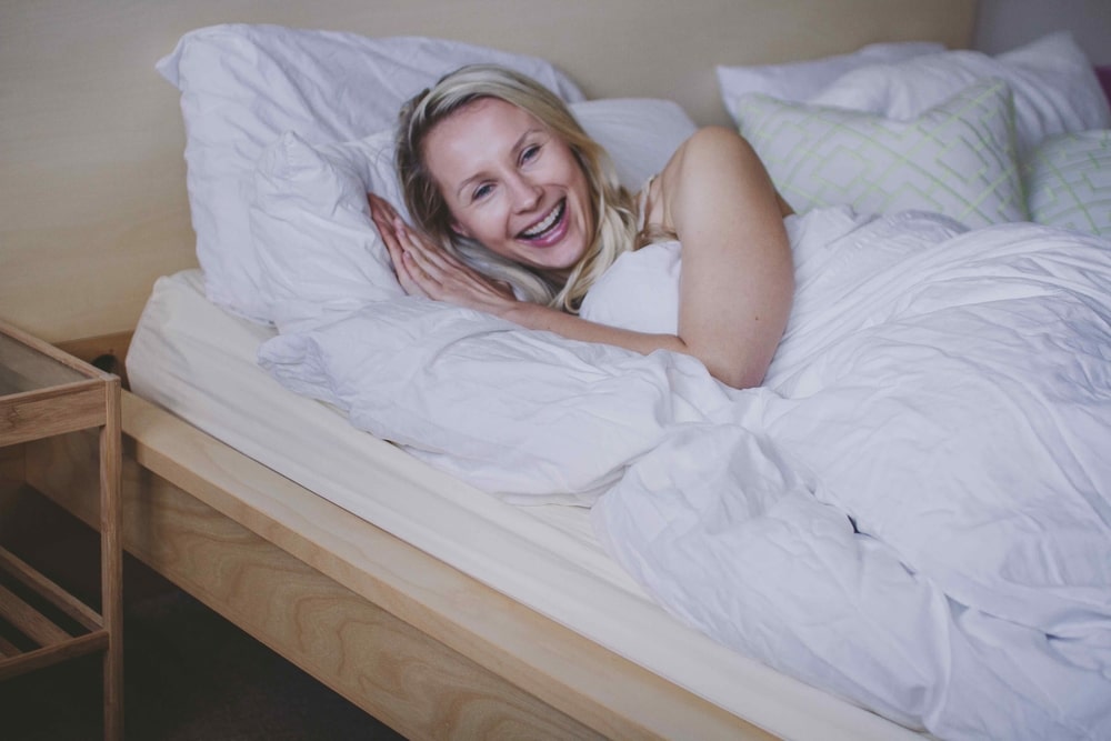 A Beautiful Women Smiles in Her Bed.